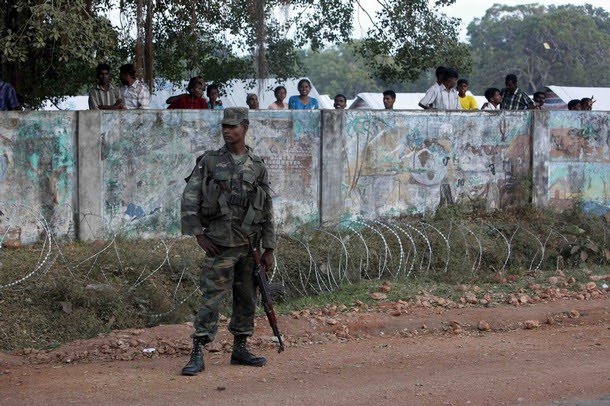 a_soldier_guards_the_wall_where_tamil_people.jpg 