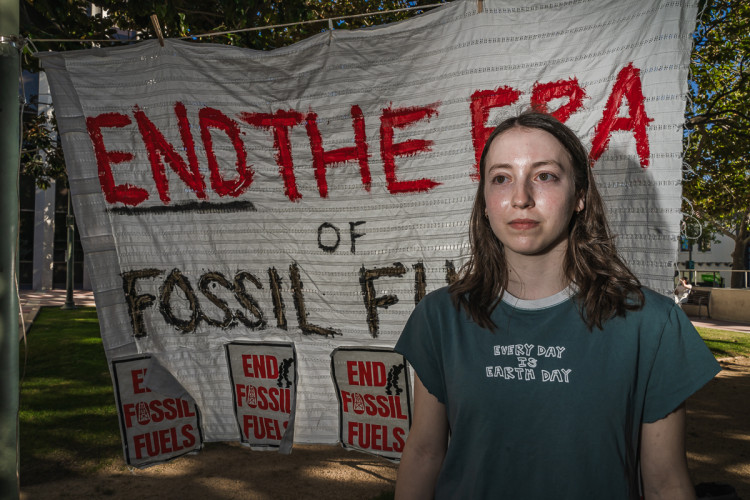 Banner says same. Teenage active wearing Earth Day t-shirt