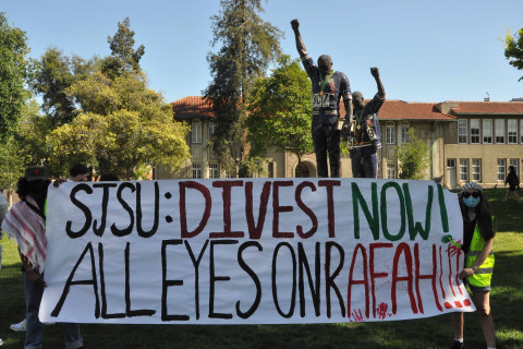 Banner in front of statue says: SJSU Divest Now All Eyes on Rafah