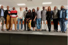 Black people standing together in line on a stage, posing for a photo