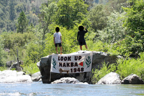 The banner with two activists above it