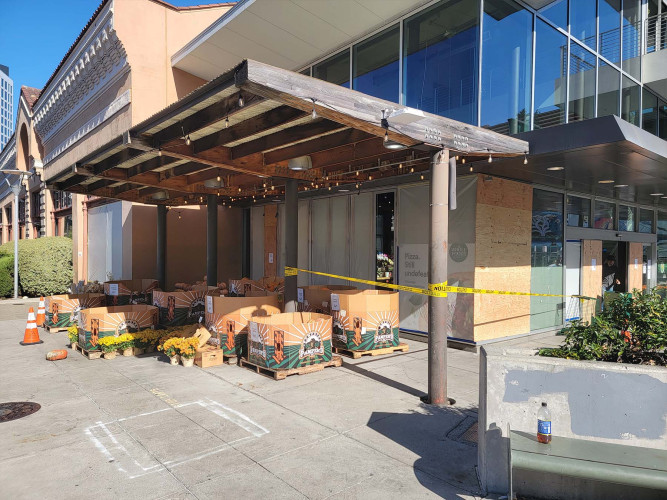 photograph of string of broken windows around the corner of whole foods