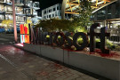 Microsoft sign covered in "blood" (red paint) with spray paint that reads "Azure: drop israel, not bombs" on the cement below